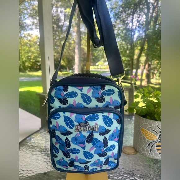 Disney Handbags - NWT- DISNEY Stitch Crossbody Bag with Blue Leaf Print.